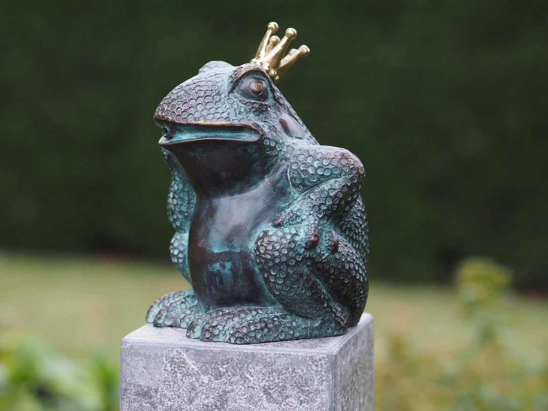 Bronze frog sculpture fountain sitting on a pedestal, wearing a golden crown. Ideal for indoor or outdoor decor.