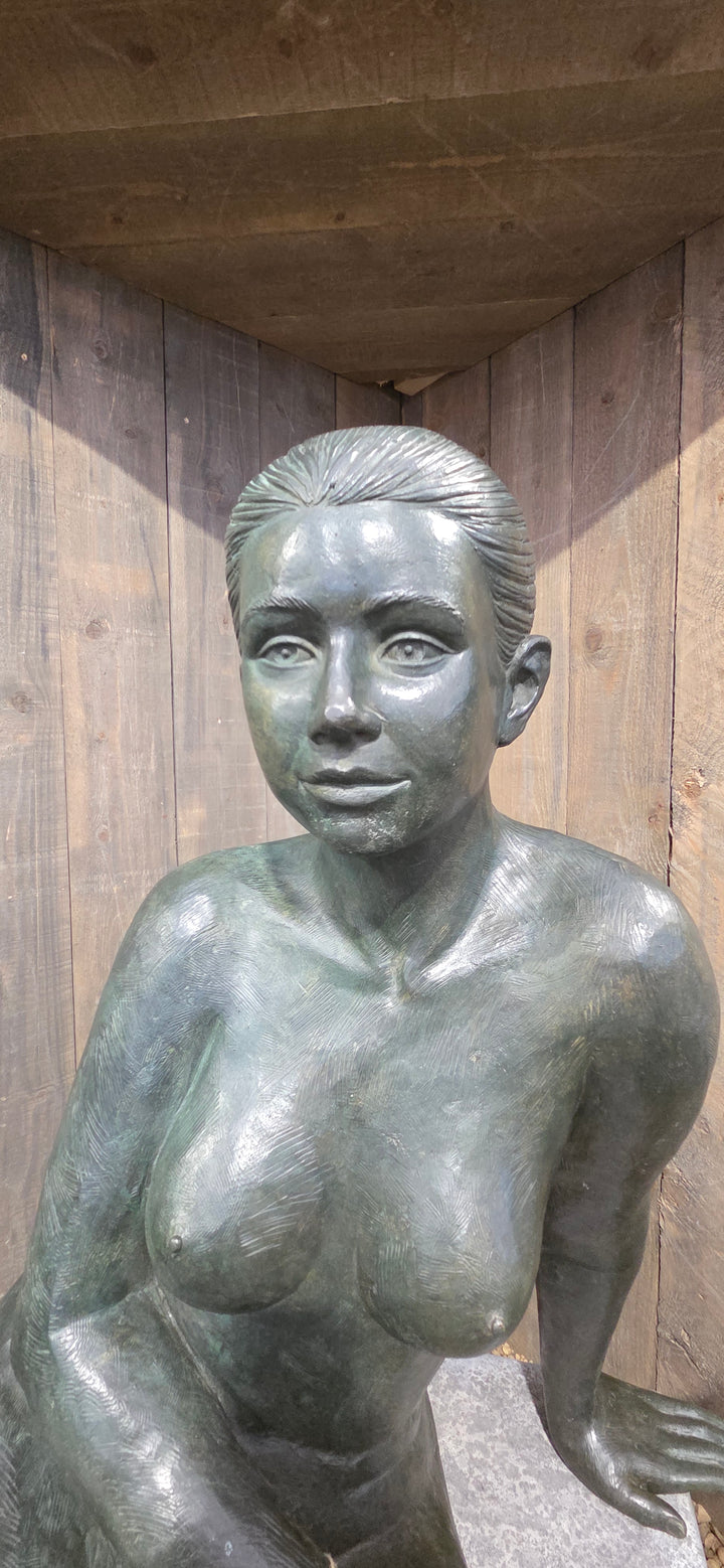 Bronze sculpture of a sitting female nude
