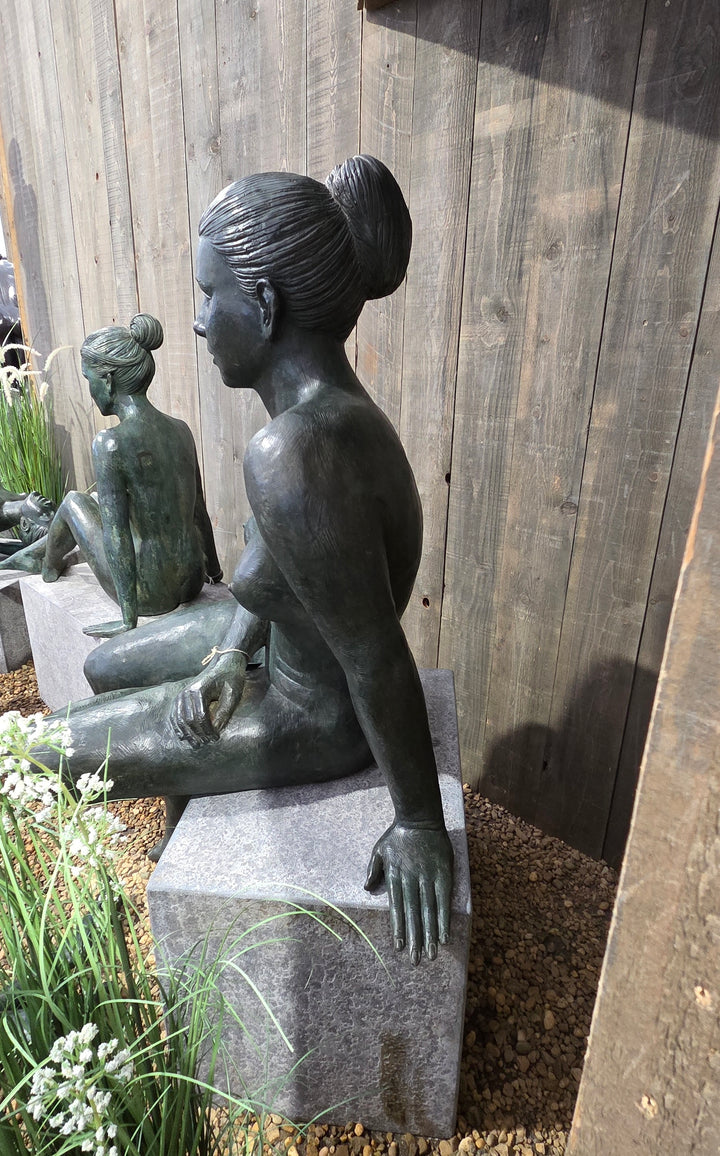 Bronze sculpture of a sitting female nude