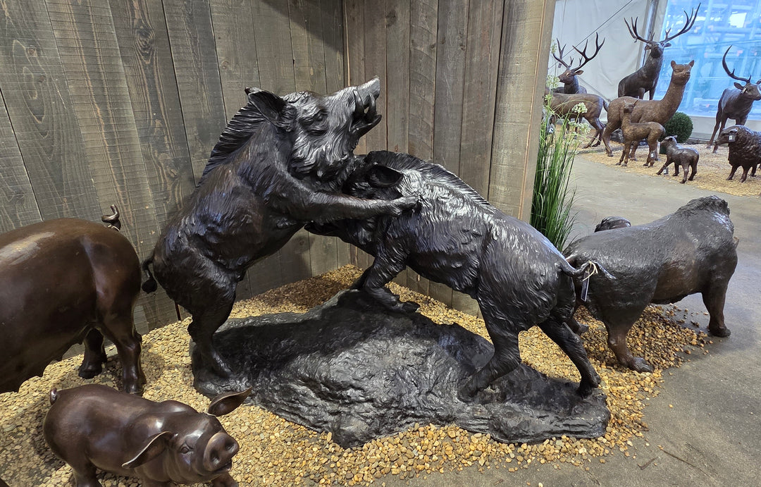 Lifesize bronze sculpture of two fighting wild boars