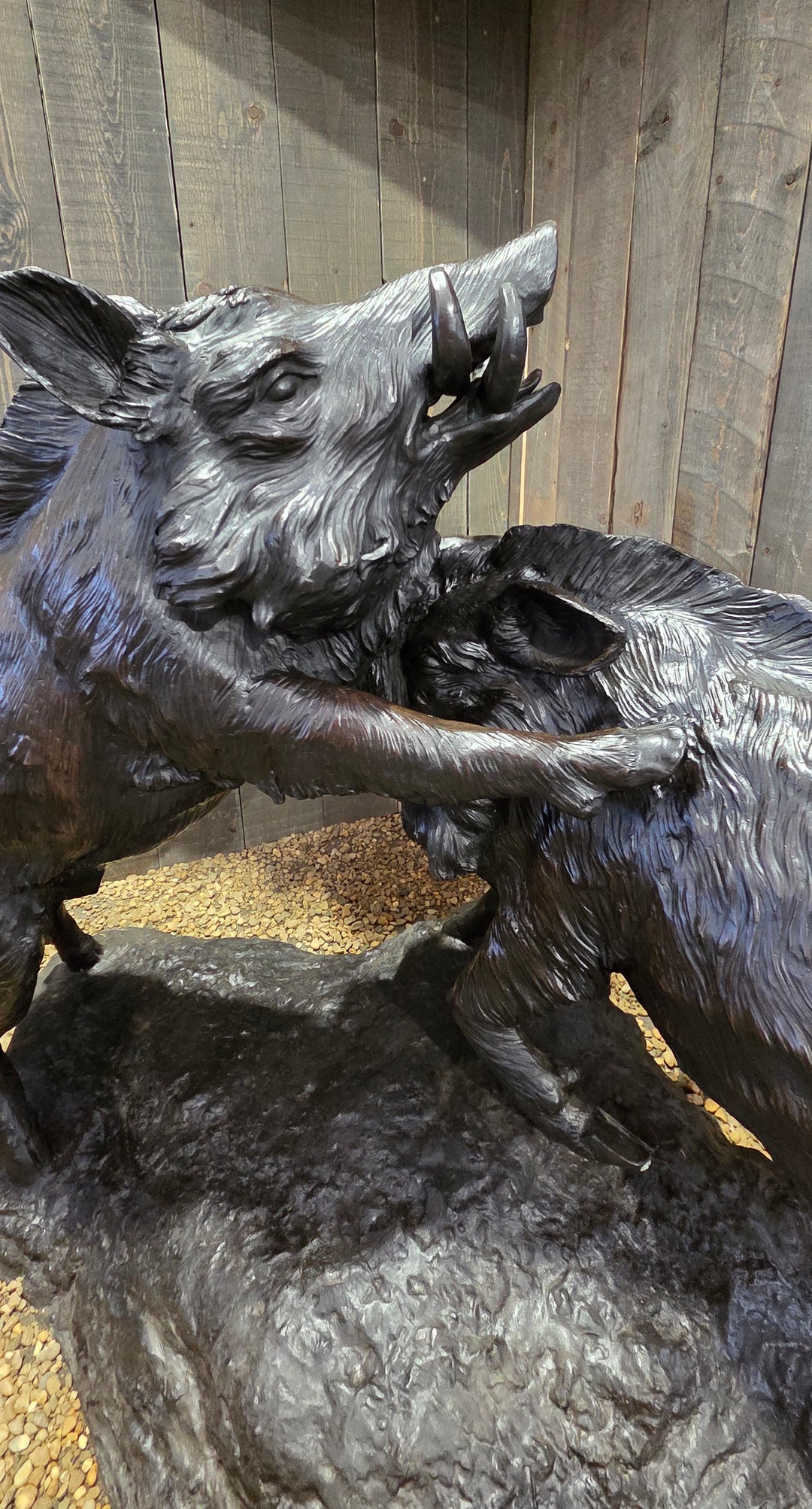 Lifesize bronze sculpture of two fighting wild boars