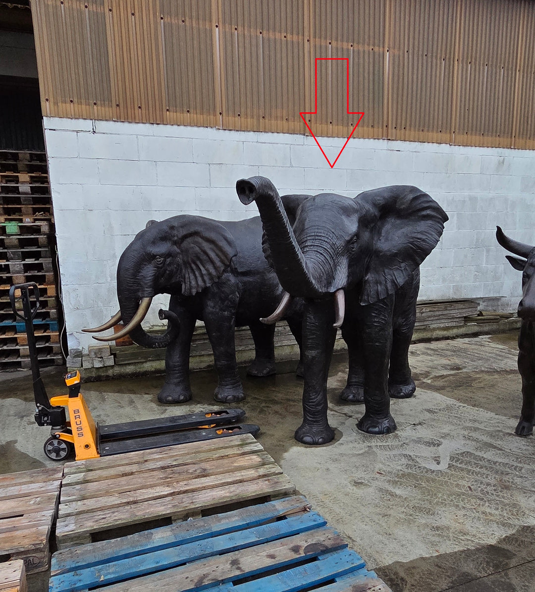 Lifesize bronze sculpture of an elephant with raised trunk