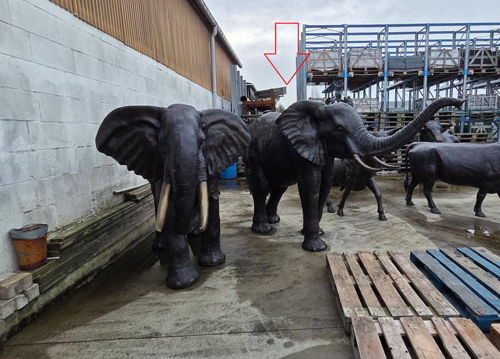 Lifesize bronze sculpture of an elephant with raised trunk