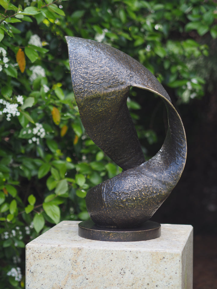 Modern bronze sculpture of a wave in motion
