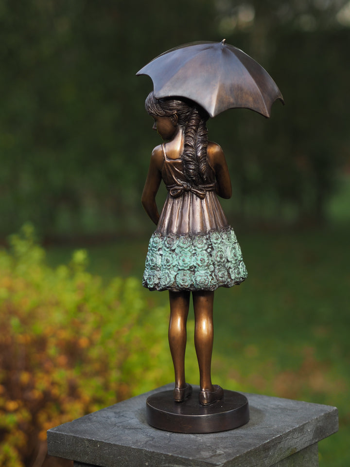 Bronze sculpture of a young girl with an umbrella