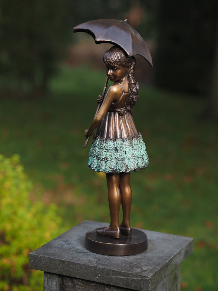 Bronze sculpture of a young girl with an umbrella