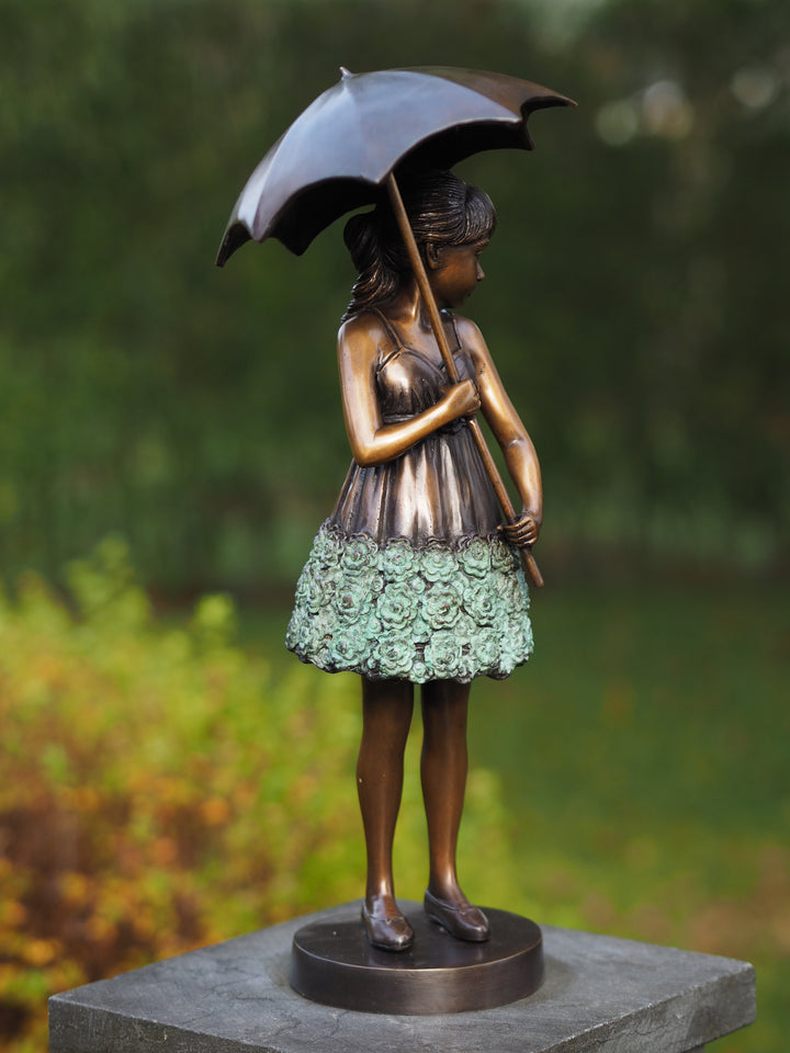 Bronze sculpture of a young girl with an umbrella