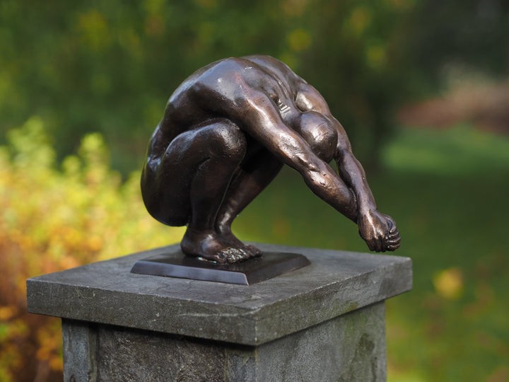 Bronze sculpture of a crouching man in a moment of balance (medium)
