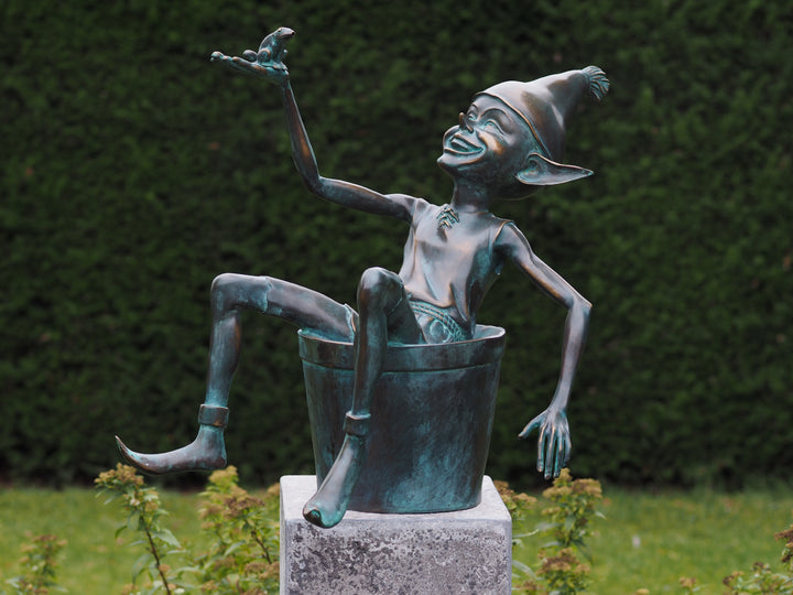 Bronze sculpture of a pixie with a frog sitting in a bucket