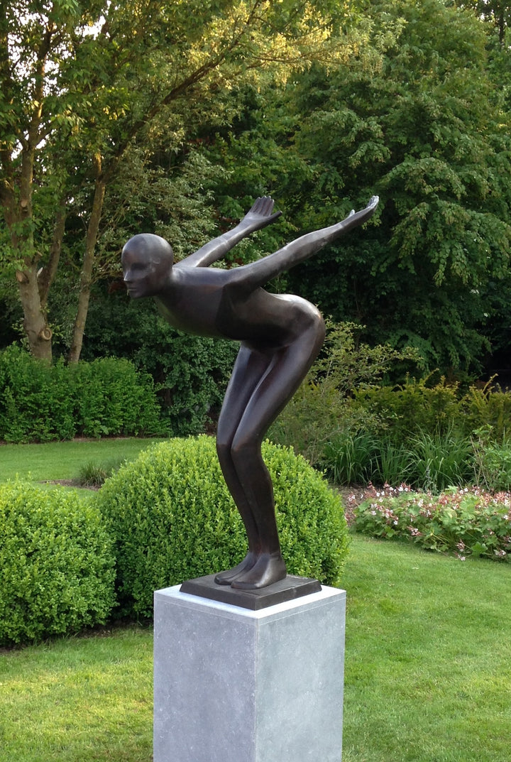 Large bronze sculpture of a poised swimmer