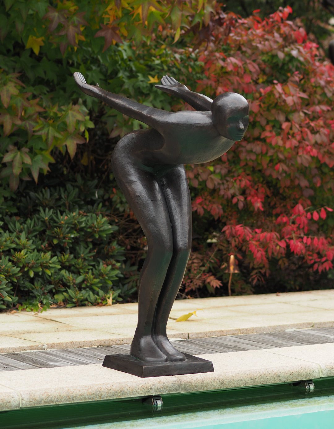 Large bronze sculpture of a poised swimmer