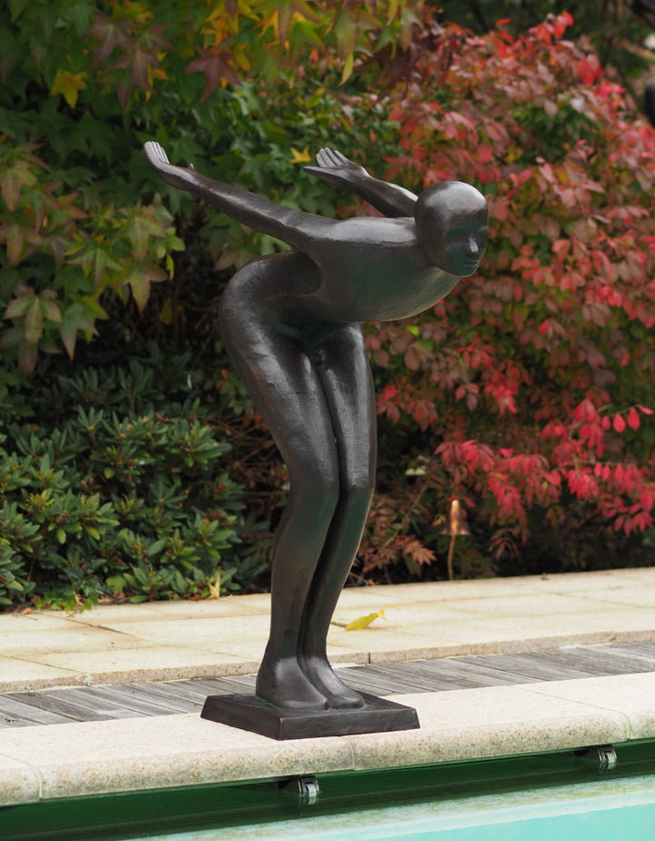 Large bronze sculpture of a poised swimmer