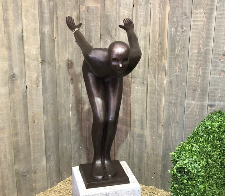 Large bronze sculpture of a poised swimmer