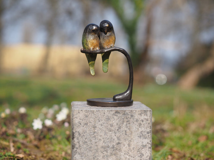 Bronze sculpture of a pair of parakeets on a branch