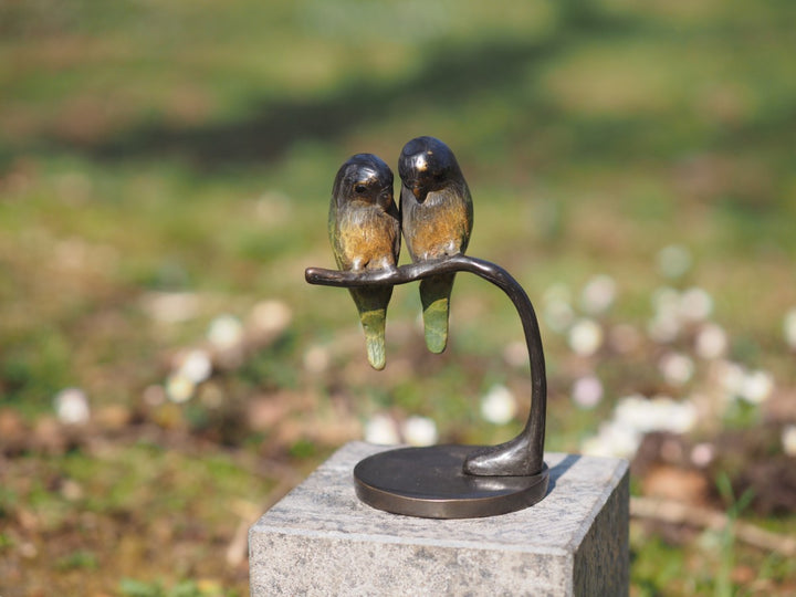 Bronze sculpture of a pair of parakeets on a branch