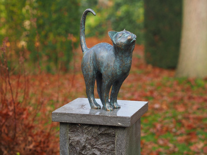 Bronze sculpture of a cat with lifted tail