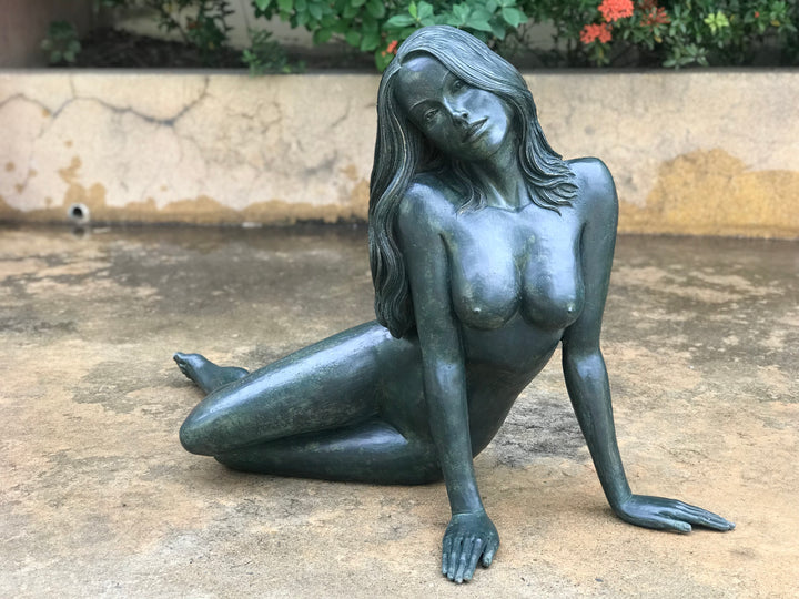 Large bronze sculpture of a reclining nude woman