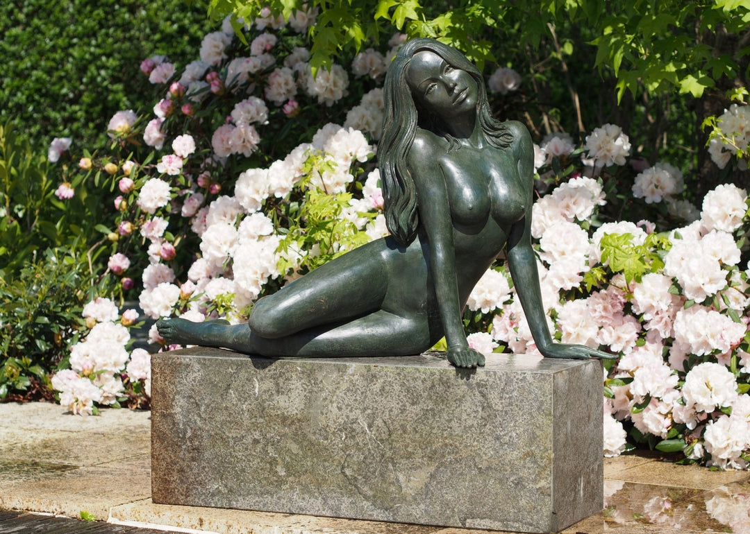 Large bronze sculpture of a reclining nude woman