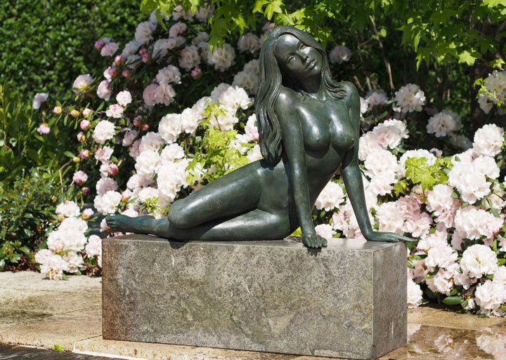 Large bronze sculpture of a reclining nude woman