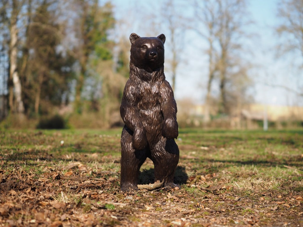 Large bronze sculpture of a standing bear cub