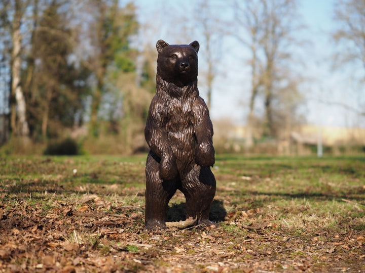 Large bronze sculpture of a standing bear cub