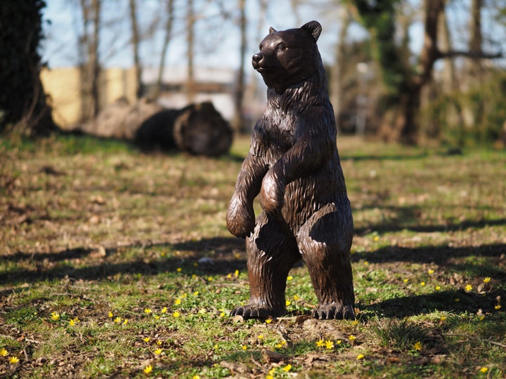 Large bronze sculpture of a standing bear cub