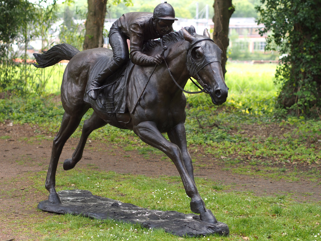 Lifesize bronze sculpture of a jockey on racehorse at full speed