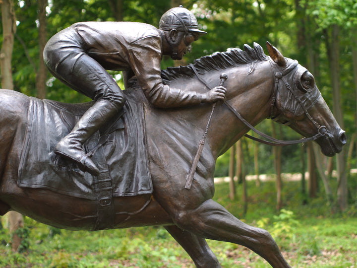 Lifesize bronze sculpture of a jockey on racehorse at full speed