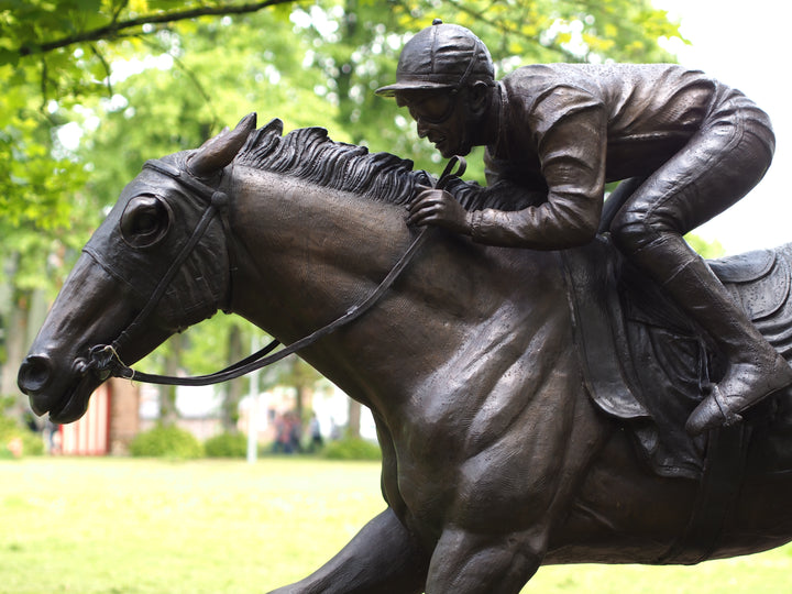 Lifesize bronze sculpture of a jockey on racehorse at full speed
