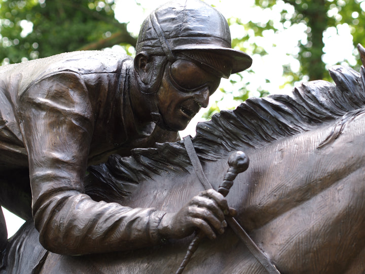 Lifesize bronze sculpture of a jockey on racehorse at full speed