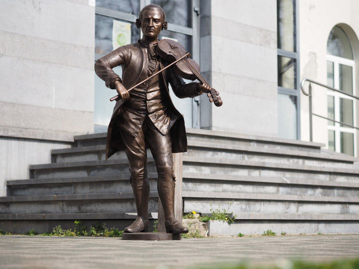 Lifesize bronze sculpture of Mozart playing the violin