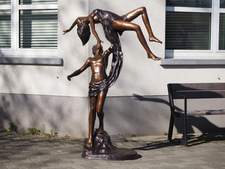 Lifesize bronze sculpture of a couple dancing gracefully