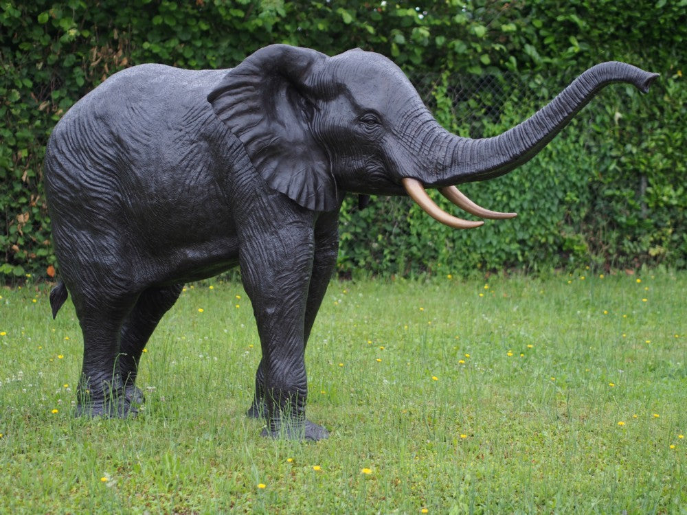 Lifesize bronze sculpture of an elephant with raised trunk