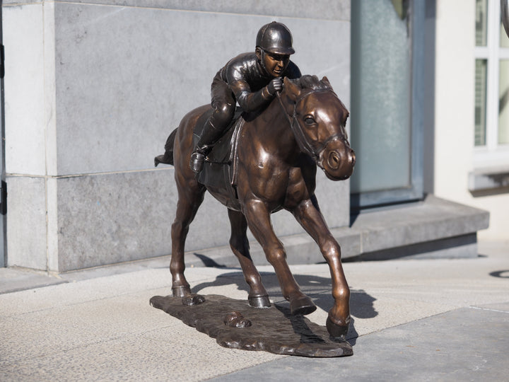 Large bronze sculpture of a jockey on horse