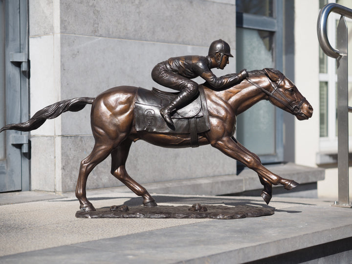 Large bronze sculpture of a jockey on horse
