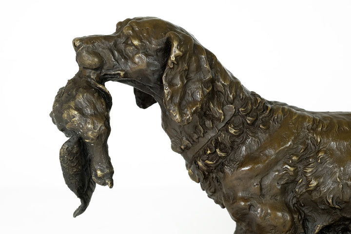 Bronze sculpture of a hunting dog with prey