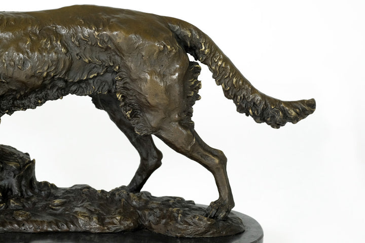 Bronze sculpture of a hunting dog with prey