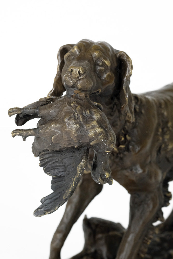 Bronze sculpture of a hunting dog with prey
