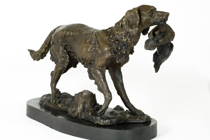 Bronze sculpture of a hunting dog with prey