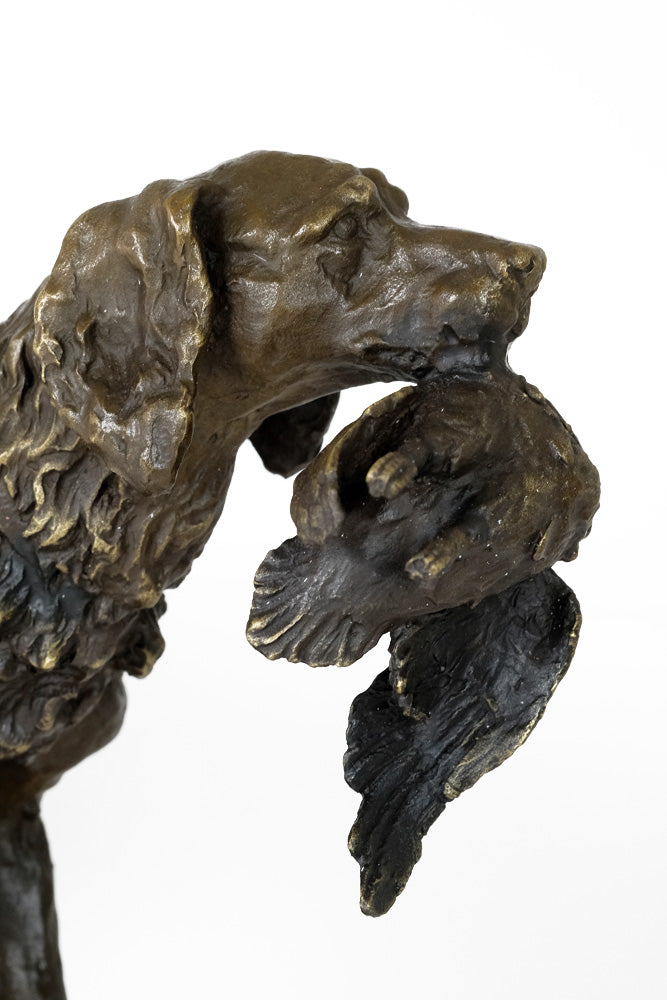 Bronze sculpture of a hunting dog with prey