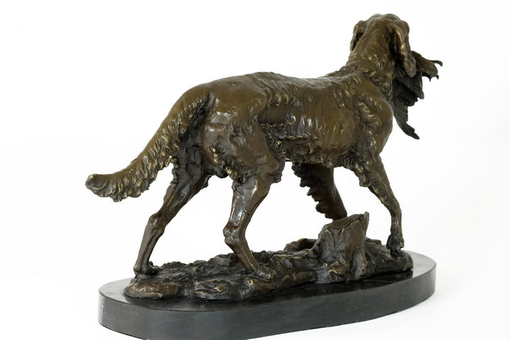 Bronze sculpture of a hunting dog with prey