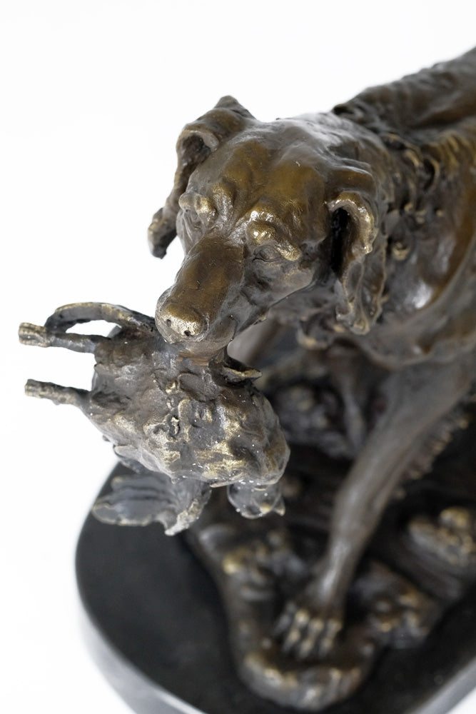 Bronze sculpture of a hunting dog with prey