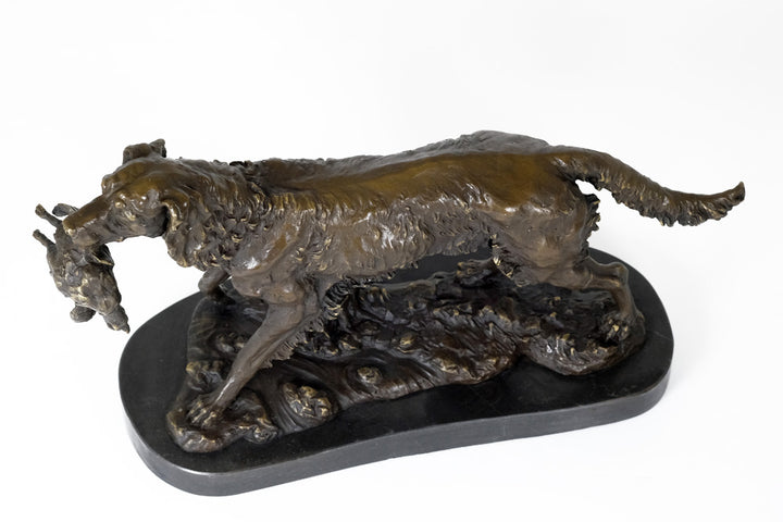 Bronze sculpture of a hunting dog with prey