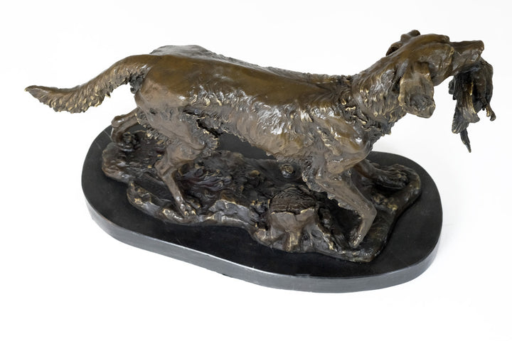 Bronze sculpture of a hunting dog with prey