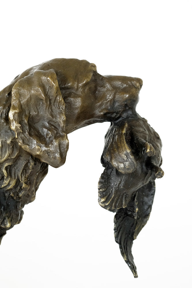 Bronze sculpture of a hunting dog with prey
