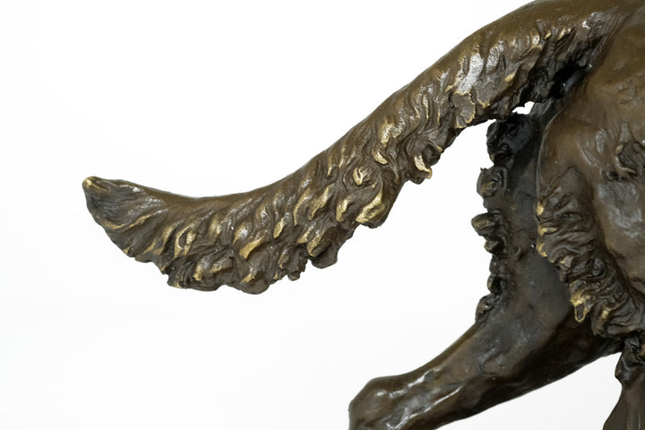Bronze sculpture of a hunting dog with prey
