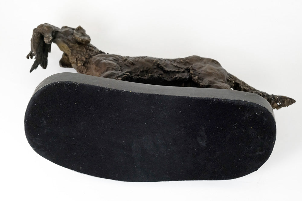 Bronze sculpture of a hunting dog with prey