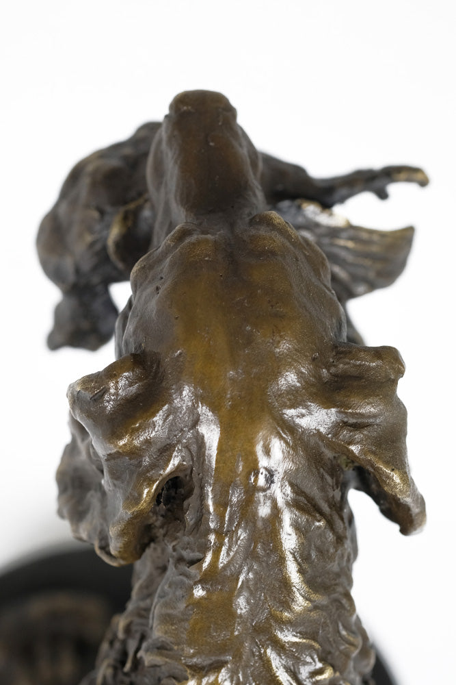 Bronze sculpture of a hunting dog with prey