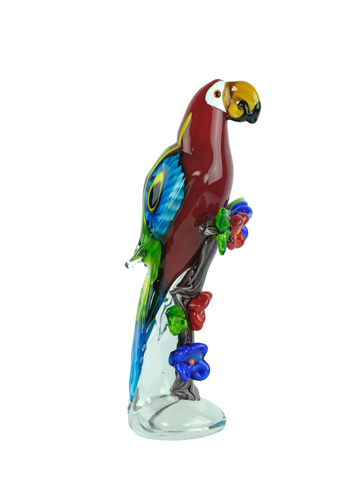 Colourful glass sculpture of a scarlet macaw sitting on a branch