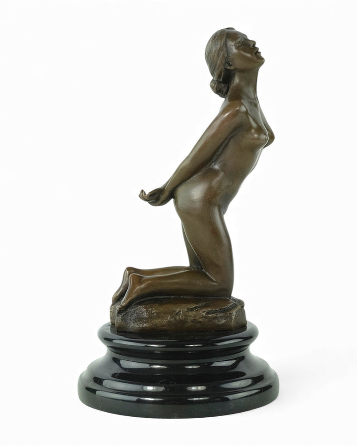 Bronze sculpture of a submissive kneeling female nude
